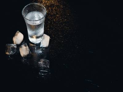 Vodka-shot-with-ice-black-table-copy-space